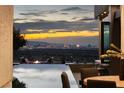 Enjoy breathtaking city views from this home's outdoor area featuring a pool, fire pit, and comfortable seating at 1491 Reims Dr, Henderson, NV 89012