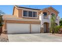 Two-story home featuring a two-car garage and a small balcony with white railings at 1798 Lakewood Dr, Henderson, NV 89012
