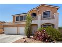 Charming two-story house featuring a balcony, desert landscaping, and a two-car garage at 1798 Lakewood Dr, Henderson, NV 89012