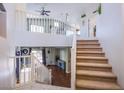 Open floor plan featuring stairs to the second floor with neutral carpeted treads at 1844 Ghost Trace Ave, Las Vegas, NV 89183