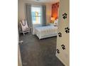 Cozy bedroom with paw print accents, a window with neighborhood view, and a comfortable bed with patterned linens at 1900 Arietta Vista St, Henderson, NV 89044