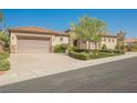 Charming single-story home with a well-manicured lawn, mature landscaping, and a two-car garage at 2080 Powder Springs St, Henderson, NV 89052
