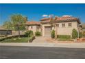 Charming single-story home with a well-manicured lawn, mature landscaping, and a two-car garage at 2080 Powder Springs St, Henderson, NV 89052