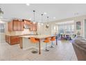 A well-appointed open kitchen featuring an island with barstool seating and modern appliances at 2194 Trivero St, Henderson, NV 89044