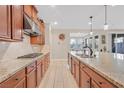 Spacious kitchen featuring modern appliances, granite countertops, and tile flooring at 2194 Trivero St, Henderson, NV 89044