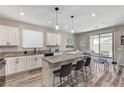 Well lit kitchen featuring granite countertops, white cabinets, and stainless steel appliances at 2531 Dollison Ave, North Las Vegas, NV 89081
