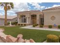 Charming home with manicured lawn, mature landscaping, and a secure front gate at 2624 Spalding Dr, Las Vegas, NV 89134