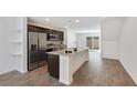 Modern kitchen with granite island, stainless steel appliances, and open access to the living area at 2747 Tahiti Grape Way # 2, Las Vegas, NV 89183
