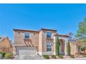 Charming two-story home featuring a well-maintained front yard and an attached two-car garage at 3525 Dover Bay St, Las Vegas, NV 89129