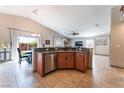 Open kitchen design with stainless steel appliances, breakfast bar, and access to the dining area at 4508 Dragon Fly Creek Ave, North Las Vegas, NV 89031