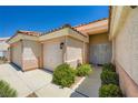 Beautiful exterior of the home showcasing the lovely entryway and three-car garage at 4904 Meadows Encore Ave, Las Vegas, NV 89131