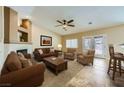 Cozy living room featuring a fireplace, neutral paint, and a ceiling fan at 4904 Meadows Encore Ave, Las Vegas, NV 89131