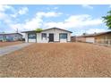 Well-maintained single-story home boasting a tidy rock garden, complemented by a clear blue sky at 50 Armstrong Cir, Henderson, NV 89015