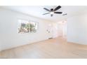 Bright, airy living room featuring fresh paint, light wood flooring, and a ceiling fan at 50 Armstrong Cir, Henderson, NV 89015