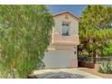 Two-story home featuring a two-car garage, desert landscaping, and a tile roof at 5004 Ironhorse Ranch Ave, Las Vegas, NV 89131