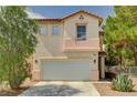 Two-story home featuring a two-car garage, desert landscaping, and a tile roof at 5004 Ironhorse Ranch Ave, Las Vegas, NV 89131