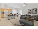 Open concept living area with a kitchen island, breakfast bar, and a comfortable seating area at 5240 Adorato Dr, North Las Vegas, NV 89031