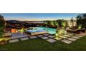 Stunning backyard oasis featuring a pool, spa, and meticulously landscaped grounds at 527 Serenity Point Dr, Henderson, NV 89012