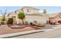 Exterior view of two-story house with a three-car garage and simple landscaping at 5539 Foxtail Ridge St, North Las Vegas, NV 89031
