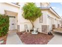 Charming front porch with desert landscaping, seating, and decorative accents at 5539 Foxtail Ridge St, North Las Vegas, NV 89031
