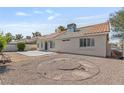 The backyard showcases a patio, desert landscaping, and the home's exterior, perfect for outdoor relaxation at 6209 Lenaking Ave, Las Vegas, NV 89122