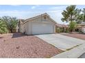 Single-story home featuring a two-car garage, low-maintenance landscaping, and a tiled roof, perfect for easy living at 6209 Lenaking Ave, Las Vegas, NV 89122