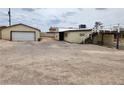 Spacious detached garage, with rear of house and access to an upper deck at 66 Lailani St, Las Vegas, NV 89110