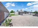 Large backyard featuring gravel landscaping, privacy walls, and potential for customization at 6741 Bonillo Dr, Las Vegas, NV 89103