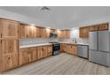 Updated kitchen features wood cabinets, stainless steel appliances and modern countertops at 6741 Bonillo Dr, Las Vegas, NV 89103