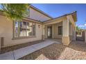 Charming home exterior with a covered porch, inviting entrance, and desert landscaping at 7525 Royal Crystal St, Las Vegas, NV 89149