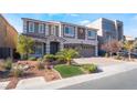 Beautiful two-story home with a well-manicured lawn and a three-car garage at 9883 Russian Hill St, Las Vegas, NV 89141