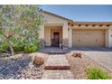 Welcoming front entrance with a paved walkway, stone accents, and desert landscaping at 1000 Via Canale Dr, Henderson, NV 89011