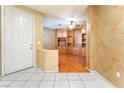 Welcoming foyer with tiled flooring and view to the beautiful built-ins in the living area at 10037 Summer Oak Ln # 102, Las Vegas, NV 89134