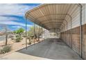 Spacious covered car port with a concrete floor and a clear view of the desert landscaping at 114 Tamarack Dr, Henderson, NV 89002