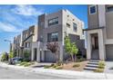 Modern townhome with neutral stucco, attached garage, and drought-tolerant landscaping at 11695 Gentle Birdsong Ave, Las Vegas, NV 89138