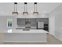 Modern kitchen with stainless appliances, an island with a sink, and pendant lighting at 11909 Pippa Ave, Las Vegas, NV 89138