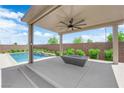 Covered outdoor patio featuring a modern fire pit and views of the private pool at 11909 Pippa Ave, Las Vegas, NV 89138