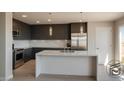 Modern kitchen boasts stainless steel appliances, sleek cabinets, and a marble countertop island at 1321 Blagg, Pahrump, NV 89048