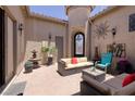 Outdoor living space featuring a comfortable seating area, fountain, and decorative art at 1329 Calle Cantar, Henderson, NV 89012