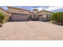 Charming single-story home featuring a decorative front door and a spacious three-car garage at 1329 Calle Cantar, Henderson, NV 89012