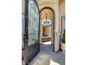 Arched entryway featuring a decorative glass and iron door leading to a private courtyard at 1329 Calle Cantar, Henderson, NV 89012