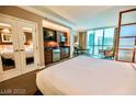 Bright bedroom features a partial kitchen, dining area, and expansive windows at 135 E Harmon Ave # 1703, Las Vegas, NV 89109