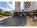 Elegant porte cochere with a circular driveway featuring lush landscaping at 135 E Harmon Ave # 1703, Las Vegas, NV 89109