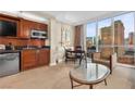 Well-equipped kitchenette and dining area with bright sunlight and city views at 135 E Harmon Ave # 407, Las Vegas, NV 89109