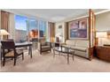 Comfortable living area offers city views, a seating area and a dining space at 135 E Harmon Ave # 407, Las Vegas, NV 89109