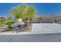 Beautiful home featuring a landscaped front yard, stone accents, large driveway, and a 3-car garage at 1744 Williamsport St, Henderson, NV 89052