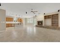 Open-concept living area with stone fireplace, built-in shelves, and tile flooring throughout at 2262 Alanhurst Dr, Henderson, NV 89052