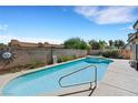 Beautiful backyard pool and spa surrounded by privacy walls and lush landscaping at 2262 Alanhurst Dr, Henderson, NV 89052