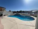 Inviting pool with an attached lake, perfect for outdoor activities and enjoying the tranquil setting at 2469 Sun Reef Rd, Las Vegas, NV 89128