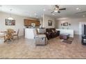 Open-concept living area featuring tile flooring that transitions into an adjacent kitchen and dining area at 2473 Luminous Stars St, Henderson, NV 89044
